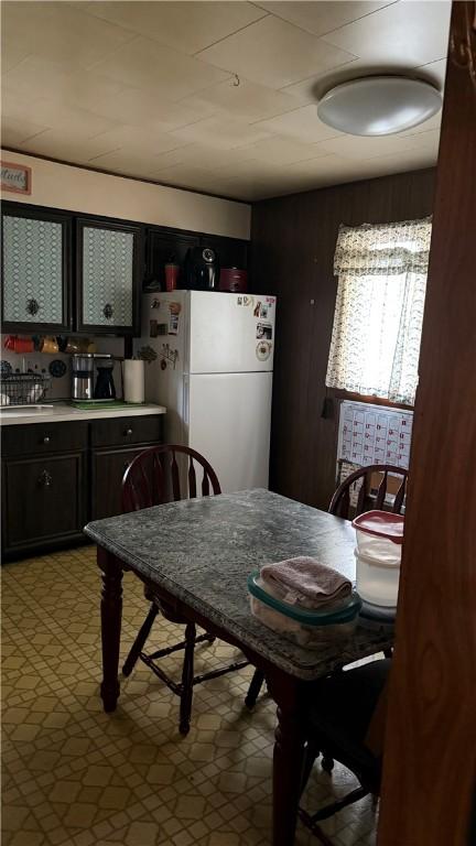 dining room with wood walls and sink