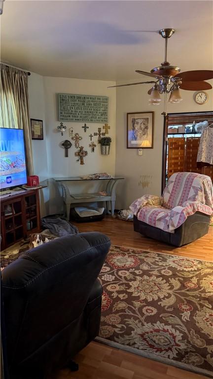 living room featuring hardwood / wood-style flooring and ceiling fan