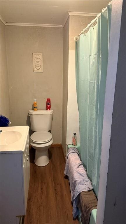 bathroom with ornamental molding, toilet, hardwood / wood-style flooring, vanity, and a shower with shower curtain