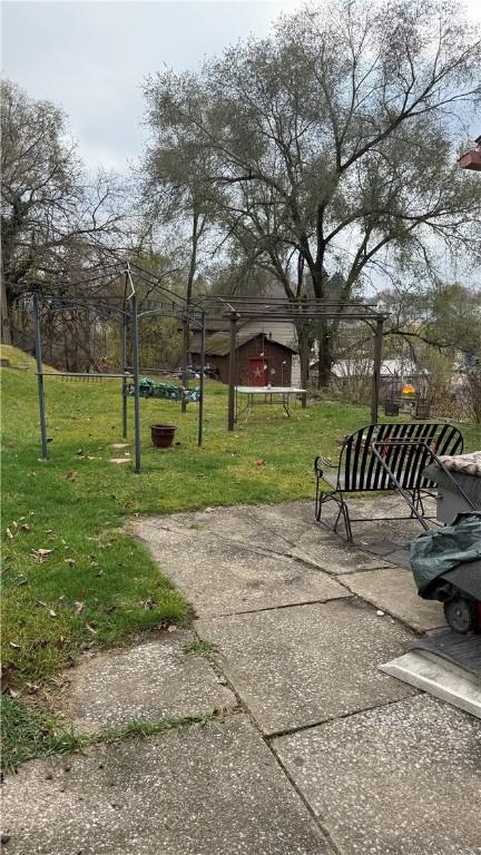 view of property's community with a yard and a patio area