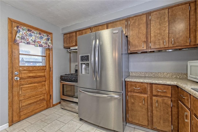 kitchen featuring stainless steel appliances and a textured ceiling