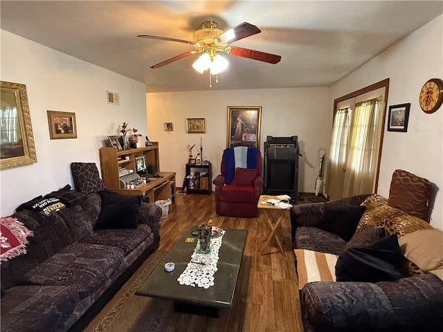 living room with ceiling fan and dark hardwood / wood-style flooring