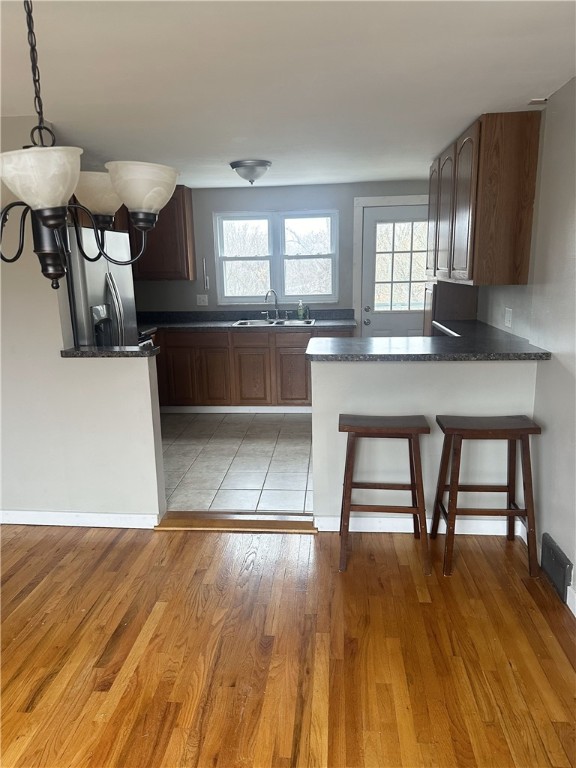 kitchen with plenty of natural light, light wood-type flooring, and sink