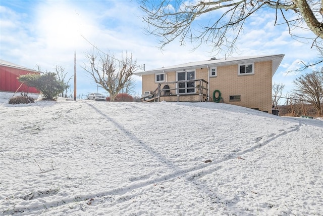 view of snow covered rear of property