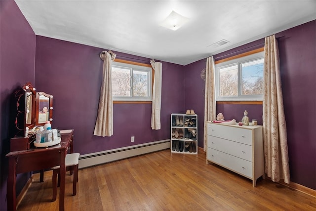 interior space with a baseboard radiator and light hardwood / wood-style floors