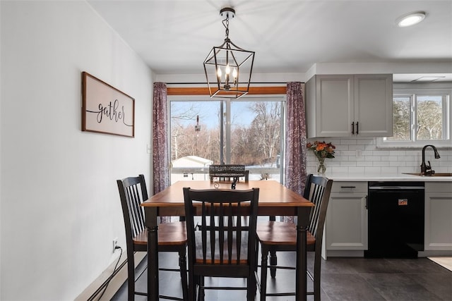 dining space featuring sink and a notable chandelier