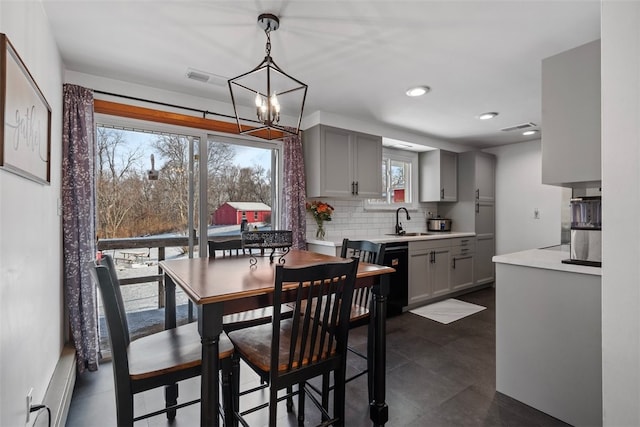 dining room with sink and a chandelier