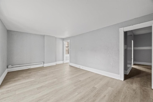 spare room with light hardwood / wood-style flooring and baseboard heating