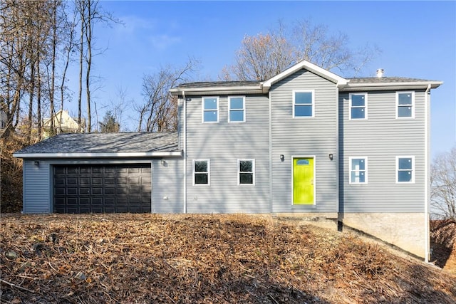 rear view of house with a garage