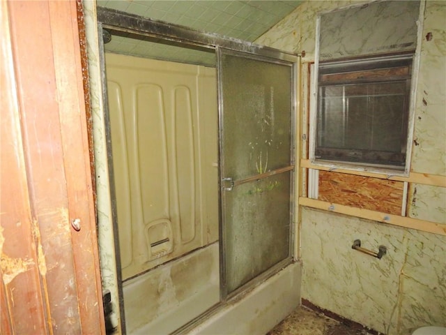 bathroom featuring combined bath / shower with glass door
