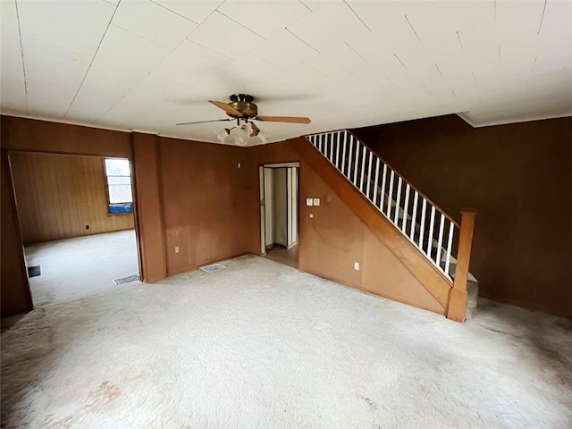 interior space featuring wood walls and ceiling fan