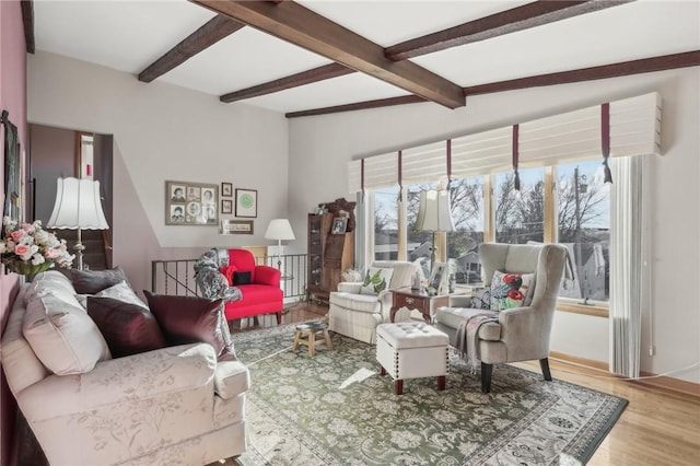 living room with beam ceiling and wood-type flooring