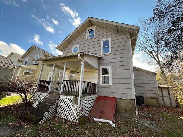 rear view of property with a porch and central AC