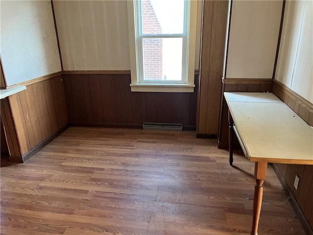 unfurnished room featuring dark wood-type flooring and wooden walls