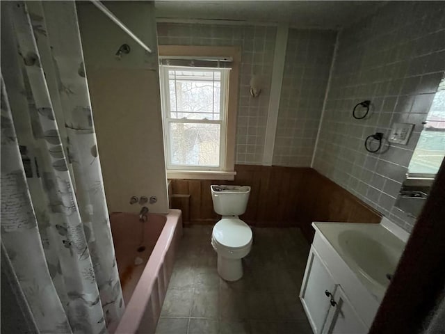 full bathroom with tile patterned flooring, vanity, shower / bathtub combination with curtain, and toilet