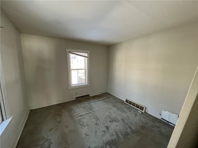 unfurnished room with visible vents, concrete flooring, and baseboards