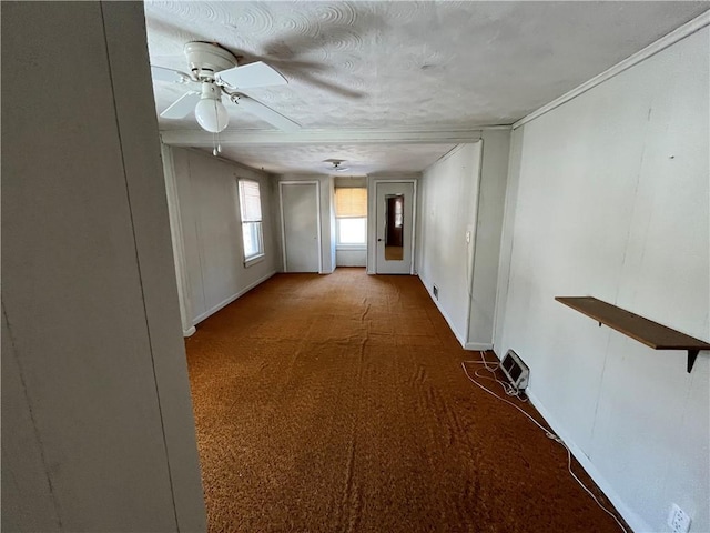 hall featuring baseboards, a textured ceiling, and carpet