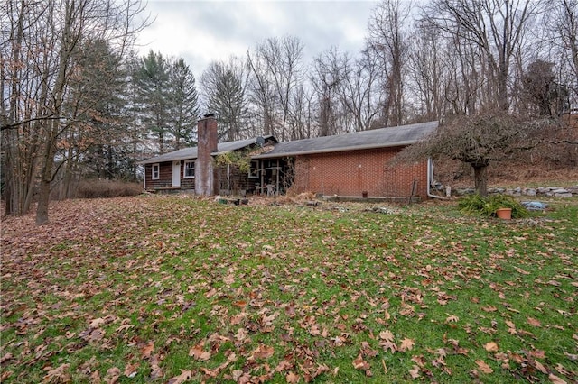 rear view of house featuring a yard