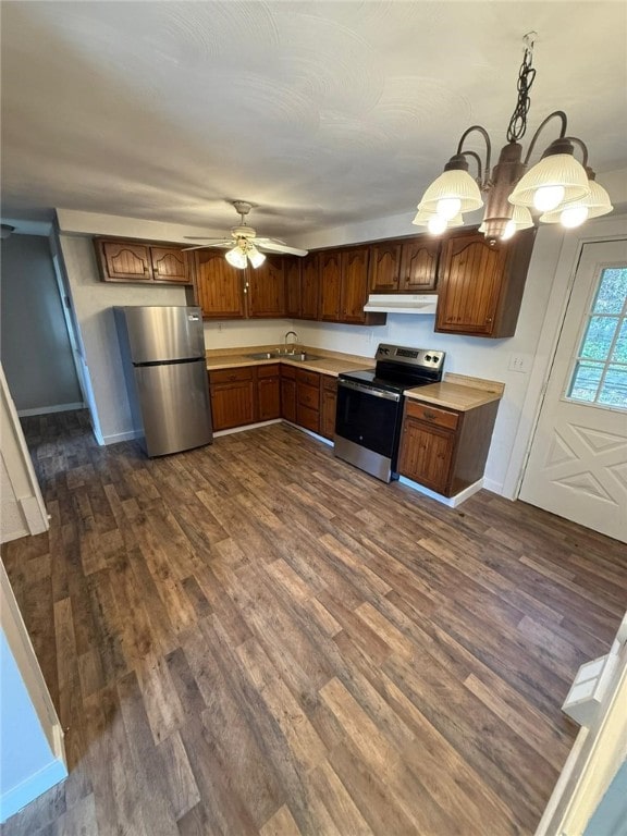 kitchen featuring pendant lighting, stainless steel appliances, dark hardwood / wood-style floors, and sink