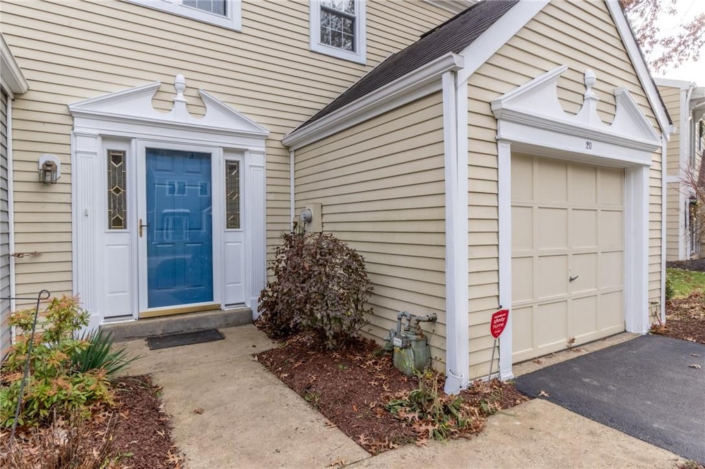 view of exterior entry with a garage