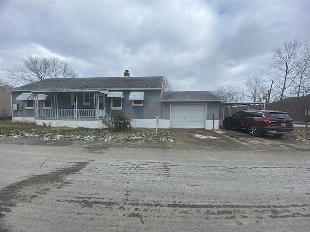 single story home featuring a carport, a porch, and a garage