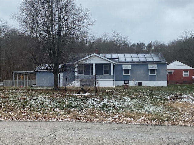 view of front of property featuring solar panels