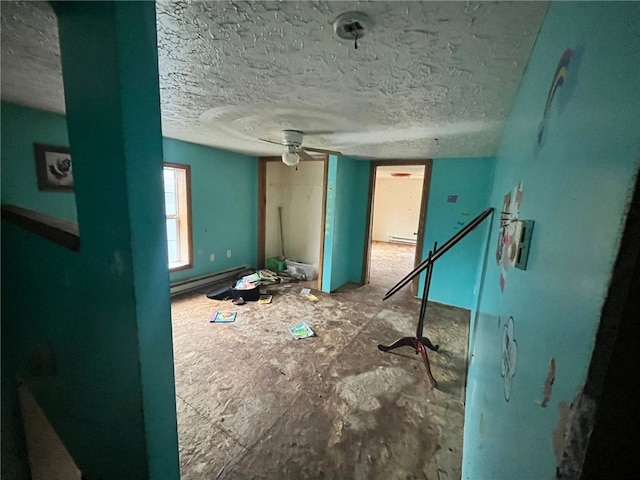 misc room with a textured ceiling and a baseboard heating unit