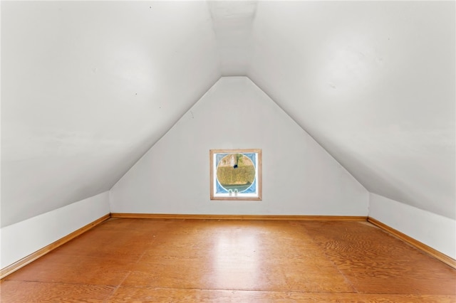 bonus room featuring wood-type flooring and vaulted ceiling