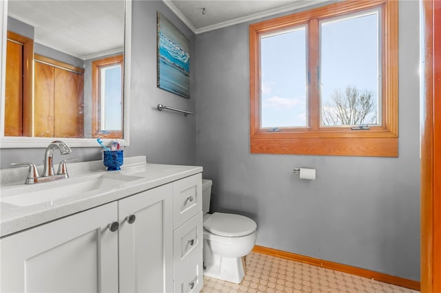 bathroom featuring toilet, vanity, and ornamental molding