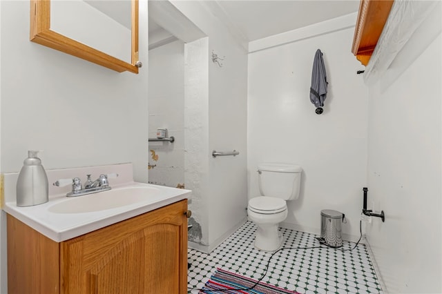 bathroom featuring tile patterned floors, vanity, and toilet