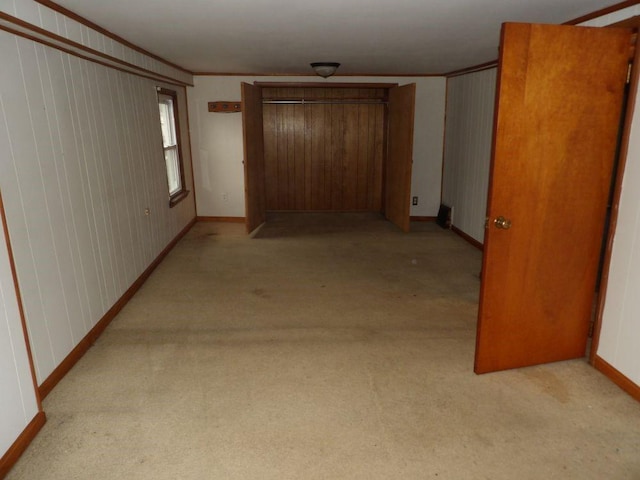 hallway featuring light carpet and ornamental molding