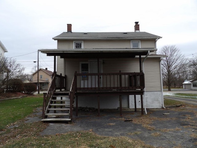 rear view of house featuring covered porch