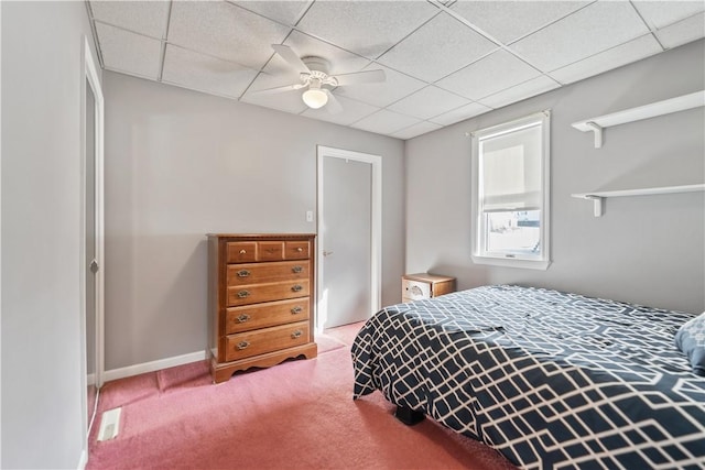 bedroom featuring carpet, a paneled ceiling, and ceiling fan