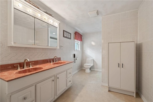 bathroom featuring decorative backsplash, vanity, toilet, and tile walls