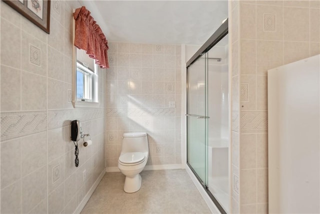 bathroom featuring tile patterned flooring, tile walls, an enclosed shower, and toilet