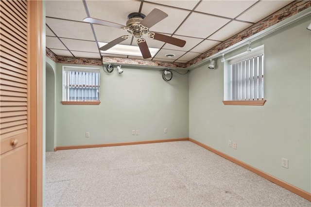 unfurnished room with carpet, a drop ceiling, and ceiling fan