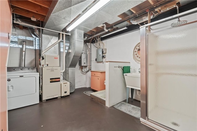 basement featuring electric panel, electric water heater, washer / dryer, and sink