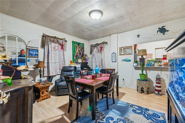 dining area with light hardwood / wood-style floors and crown molding