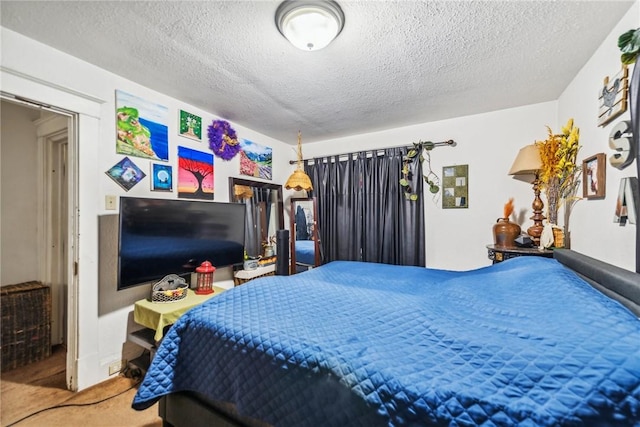 carpeted bedroom with a textured ceiling