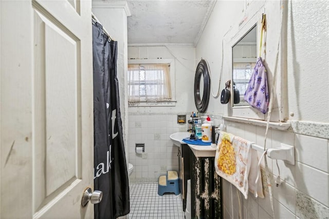 bathroom featuring ornamental molding, sink, tile walls, tile patterned flooring, and toilet