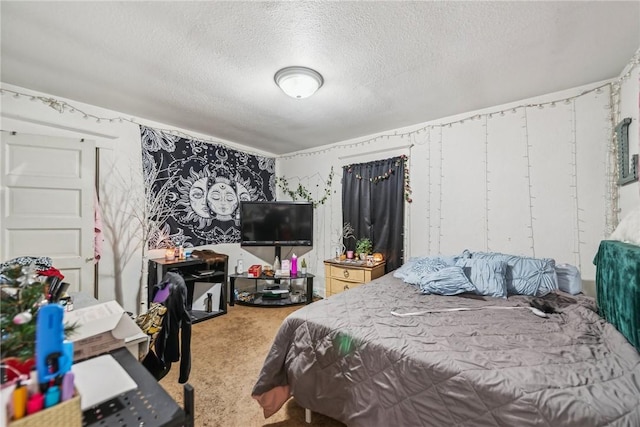 bedroom with carpet flooring and a textured ceiling