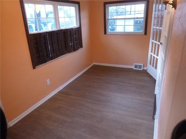 unfurnished room featuring dark wood-type flooring