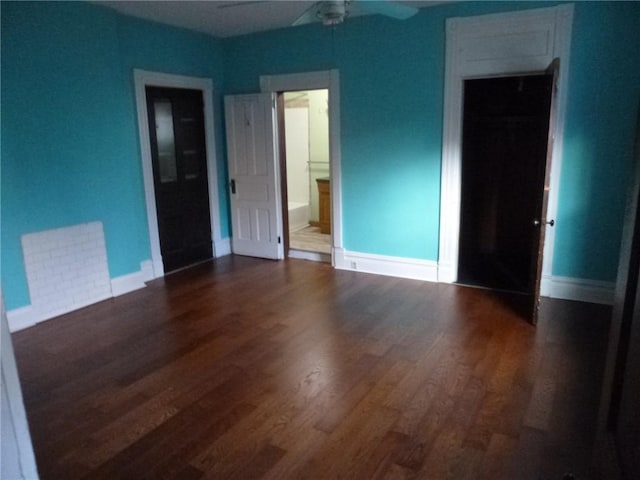 unfurnished bedroom with ensuite bathroom, ceiling fan, and dark hardwood / wood-style floors