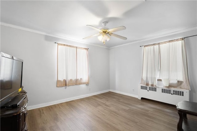 living room featuring crown molding, radiator heating unit, ceiling fan, and wood-type flooring