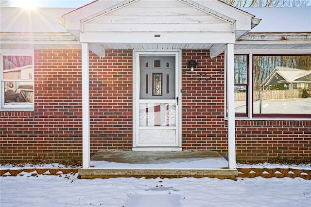 view of snow covered property entrance