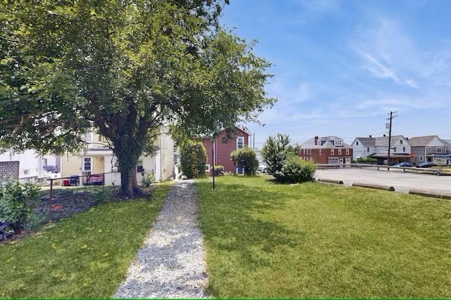 view of home's community with a yard