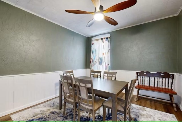 dining room with crown molding, hardwood / wood-style floors, and ceiling fan