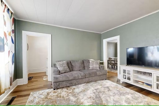 living room featuring crown molding and hardwood / wood-style flooring