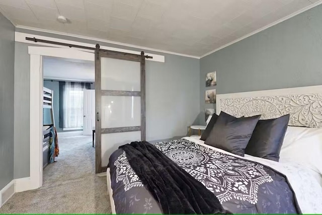 carpeted bedroom with a barn door and crown molding