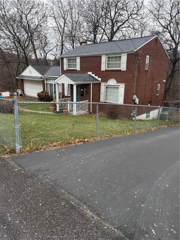 view of front of home with a garage and a front lawn